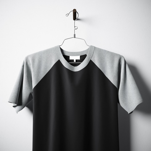 Closeup of blank cotton tshirt  black color hanging in center empty concrete wall. Clear label mockup with highly detailed textured materials. Square. Front side view. 3D rendering. - Фото, зображення