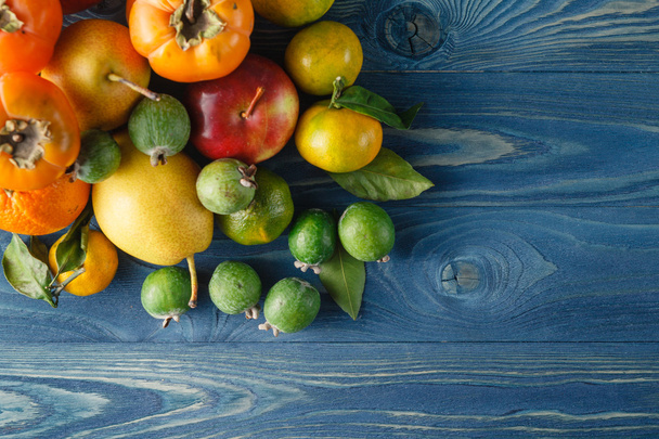 Fresh organic fruits and vegetables on wooden background - Fotografie, Obrázek