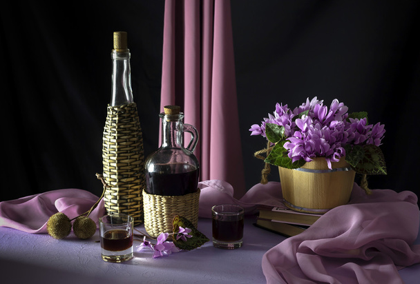 Still life with liquor and wild cyclamen  - Photo, Image