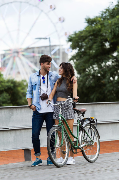 Happy young couple cycling in the city. - Φωτογραφία, εικόνα