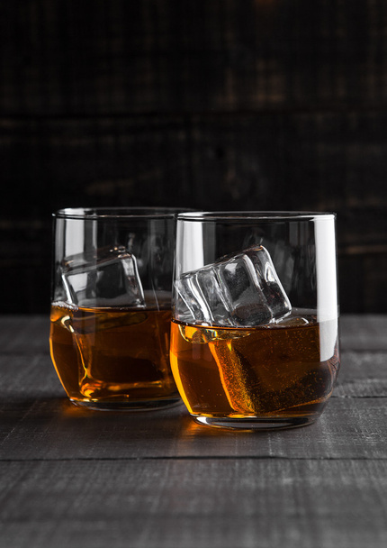 Glasses of whiskey with ice on wooden background - Valokuva, kuva