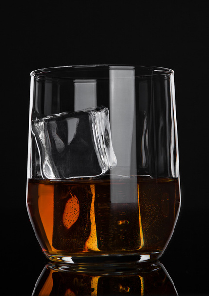 Glass of whiskey with ice on wooden background - Fotó, kép