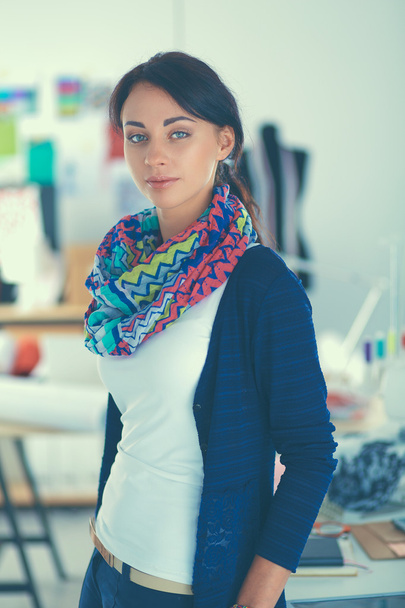Beautiful fashion woman designer standing in studio - Фото, изображение