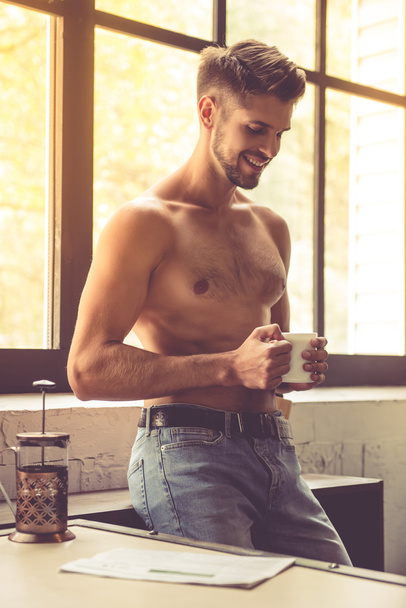 Sexy young man in kitchen - Photo, Image