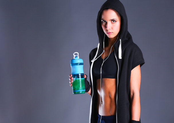 Girl with bottle in hands after sport - Foto, afbeelding