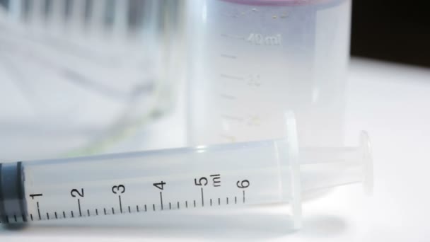 Medical test kit. syringe glasses and jar for tests - Кадры, видео