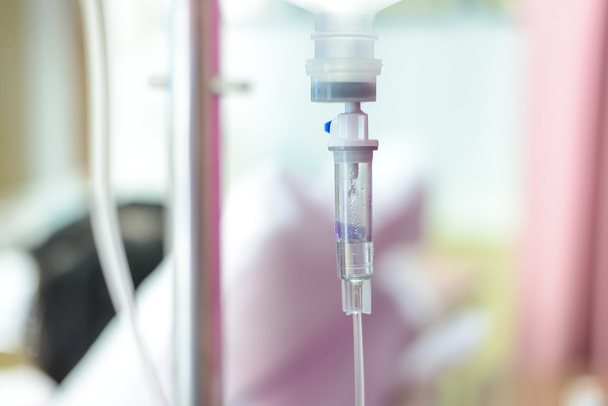 Close up IV saline solution drip for patient in hospital - Fotó, kép