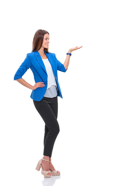 Portrait of young business woman pointing on white background - Zdjęcie, obraz