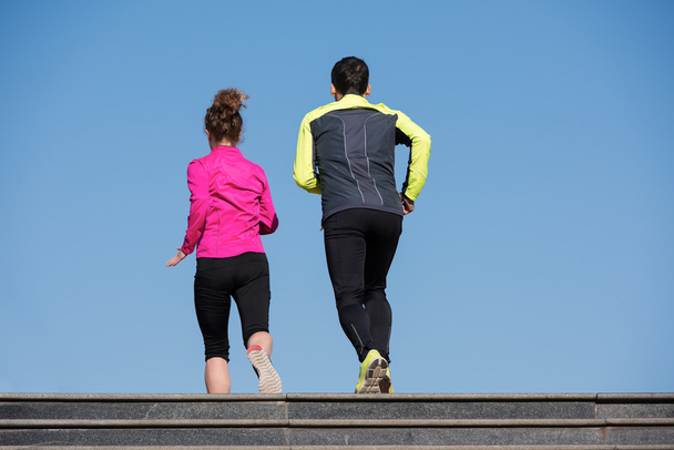 young  couple jogging on steps - Фото, зображення