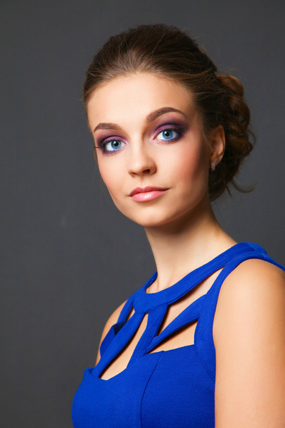 Studio shot of a beautiful young woman wearing professional makeup - Fotó, kép