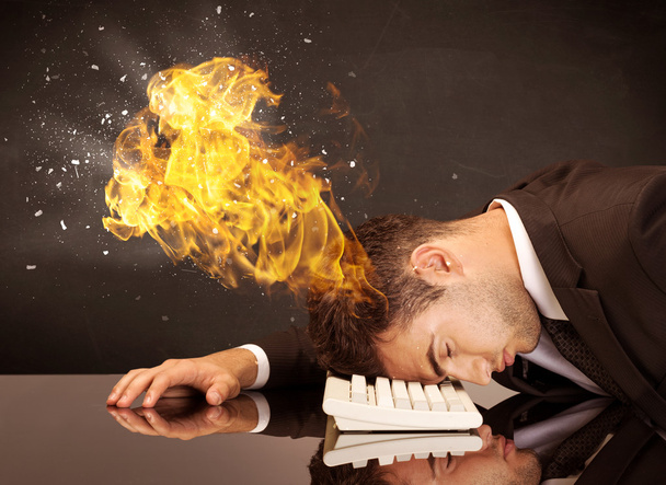 Stressed business man's head is burning - 写真・画像