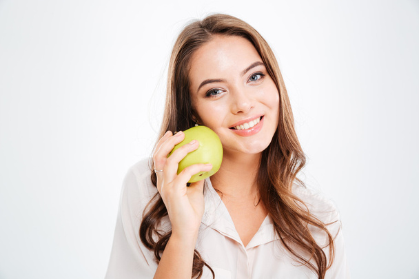 Close up portrait of a smiling girl holding green apple - Foto, Imagem