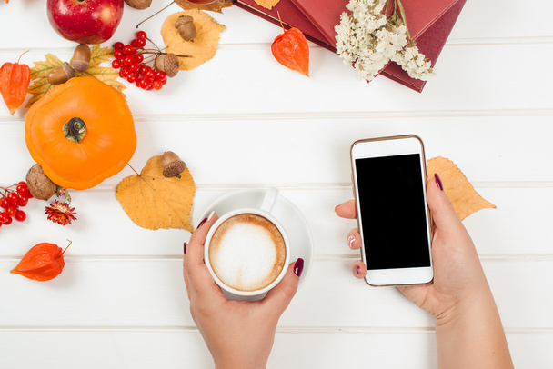 Coffee break, using cell phone. Top view of autumn background. - Zdjęcie, obraz