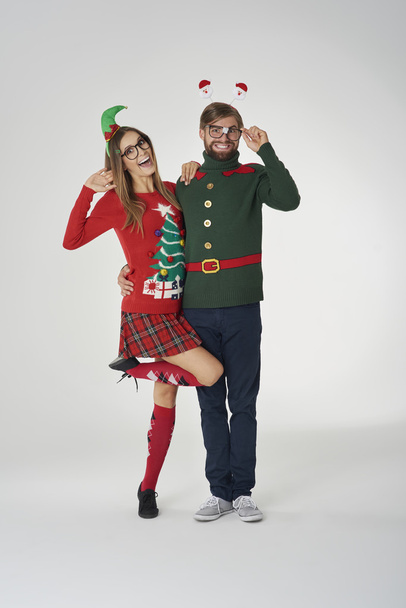 People in colorful christmas jumpers in funny holiday concept - Foto, immagini