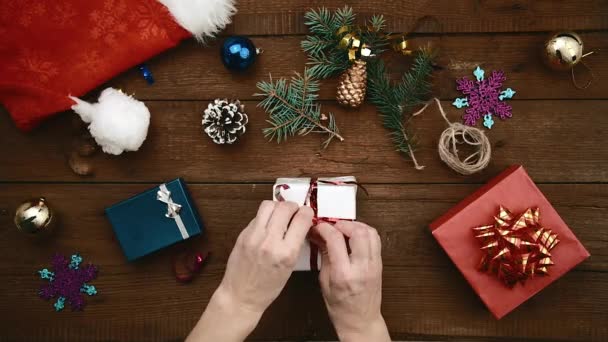 Woman packaging Christmas gift - Footage, Video