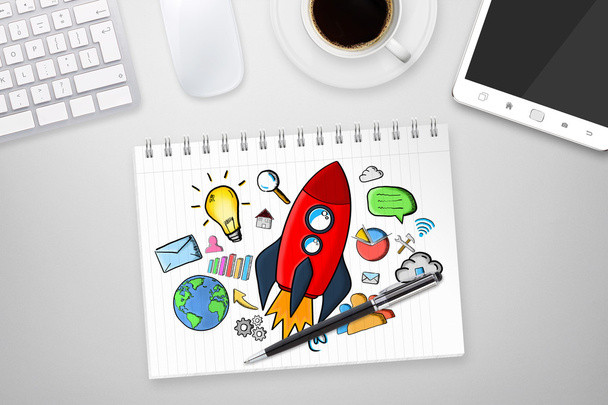 Red hand drawn rocket with icons on office background - Zdjęcie, obraz