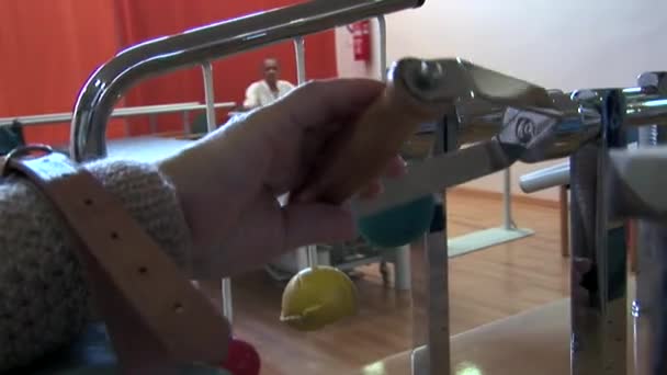 Пенсионер пожимает руку с автоматом в спортивном зале дома престарелых. - Кадры, видео
