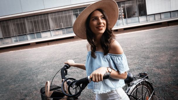Beautiful woman riding a bike outdoors - Zdjęcie, obraz
