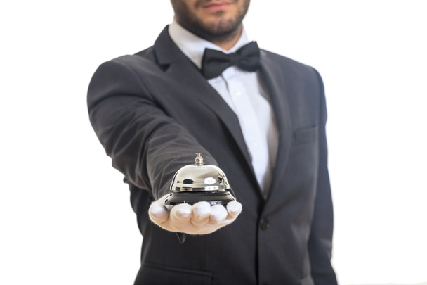 Κουδούνι υπηρεσία μπάτλερ σε ένα φορημένο γάντια χέρι - Φωτογραφία, εικόνα