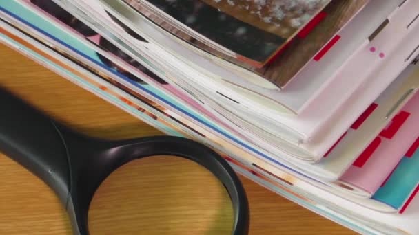Pile of newspapers and reading glasses - Footage, Video