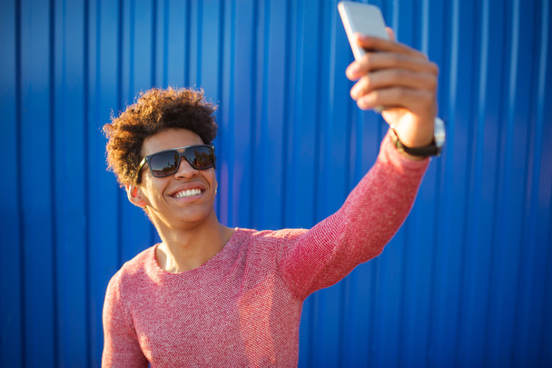 happy african guy smiling and taking a selfie photo - Photo, image