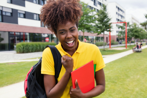 Happy african american female student outdoor on campus - 写真・画像