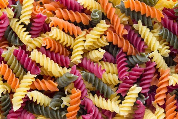 Closeup of raw eco macaroni pasta background.  - Fotó, kép