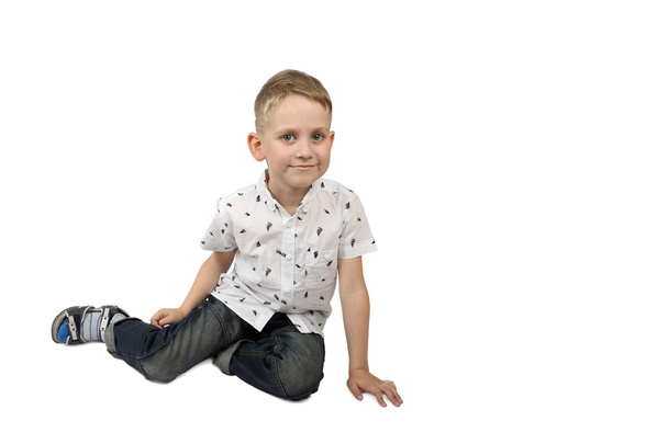 Little boy sits on floor - Фото, изображение