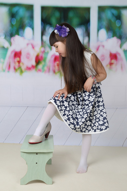 Little girl tries on mom's shoes - Photo, Image