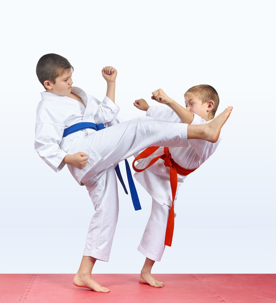 Duas crianças karateka estão batendo perna pontapé
 - Foto, Imagem