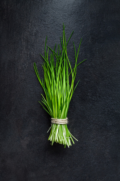 Bunch of fresh green chives on gray slate - Foto, immagini