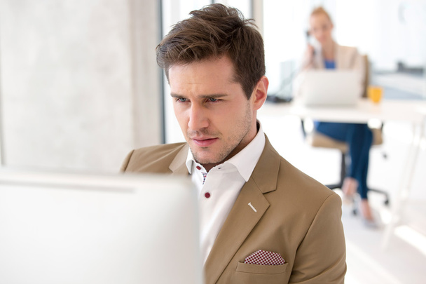 Businessman working on computer at office - Photo, Image