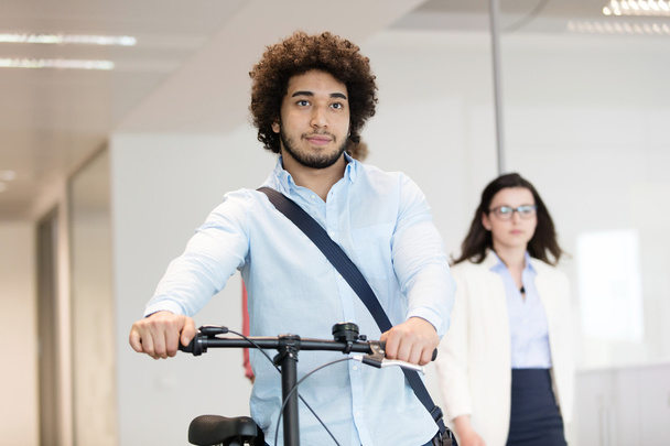 businessman holding bicycle at office  - Photo, Image