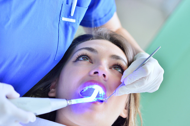 female Dentist examining Patient teeth  - Fotografie, Obrázek