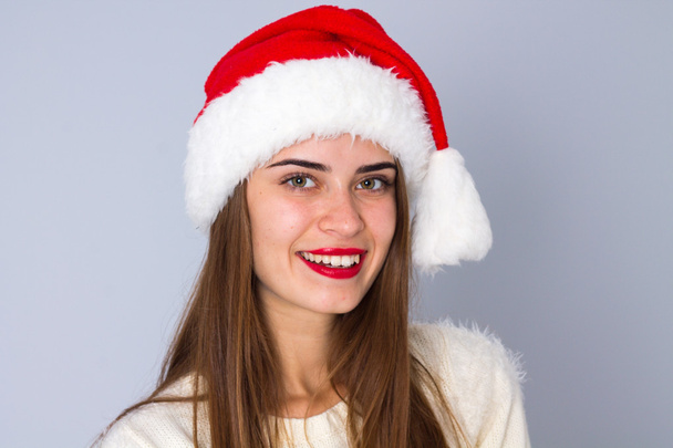 Woman in red christmas hat - Foto, imagen