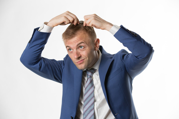 Businessman indicating hair loss - Fotó, kép
