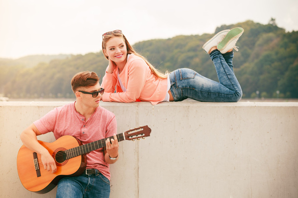 Happy couple with guitar outdoor - Photo, Image
