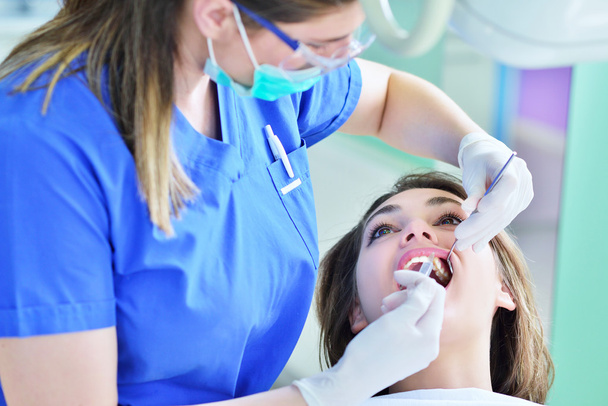 female Dentist examining Patient teeth  - Fotoğraf, Görsel