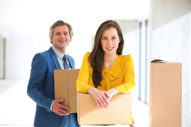 mujer de negocios con colega llevando cajas de cartón
  - Foto, Imagen