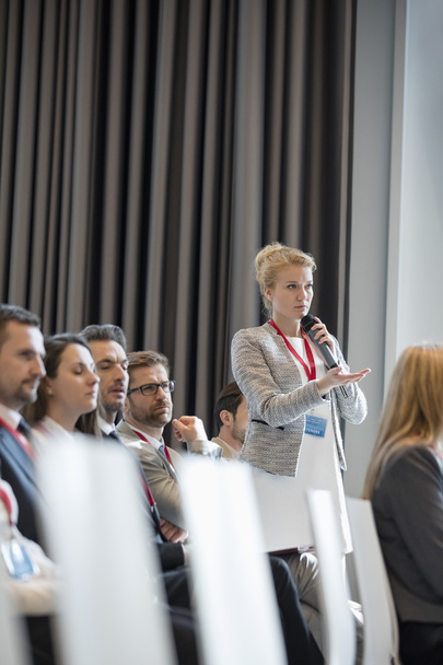 Businesswoman asking questions during seminar  - Фото, зображення