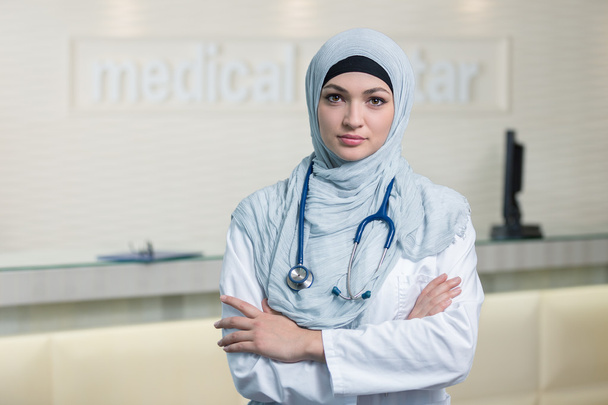 Smiling confident muslim female doctor. - Фото, изображение