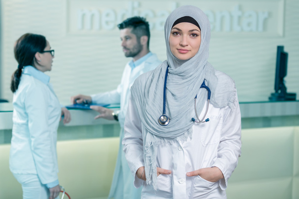 Smiling confident muslim female doctor. - Фото, изображение