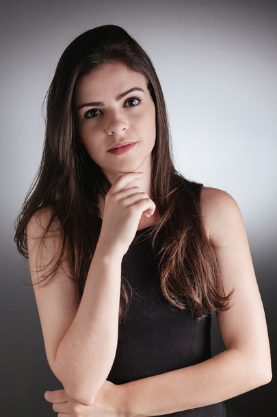 Portrait of a young businesswoman thinking on gray background. i - Φωτογραφία, εικόνα