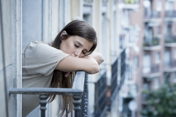 joven triste hermosa mujer sufriendo depresión buscando preocupado y desperdiciado en casa balcón
 - Foto, imagen