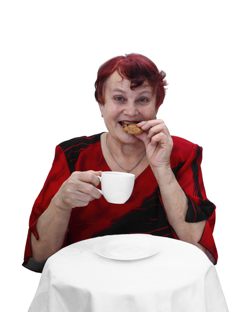 Senior woman eats cookie - Φωτογραφία, εικόνα
