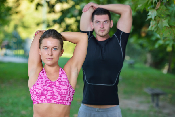 Couple stretching before jogging  - Zdjęcie, obraz
