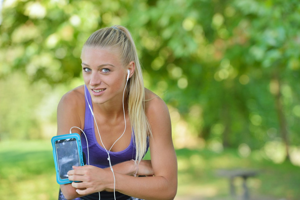 Young woman taking rest after jogging - Photo, Image