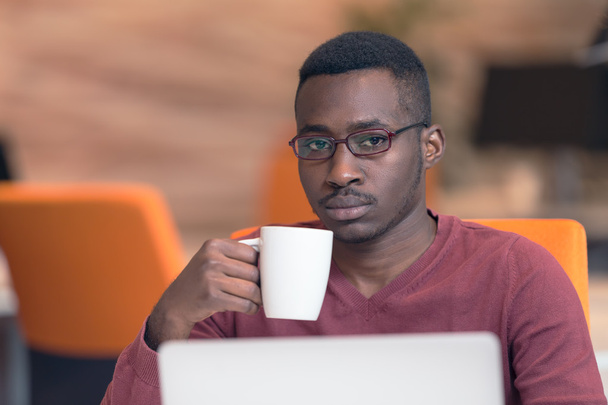 African businessman typing looking on laptop. - Fotó, kép