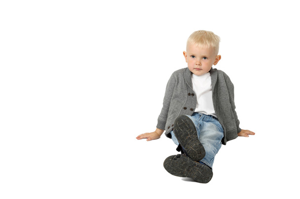 Cute little boy sits on floor - Photo, image