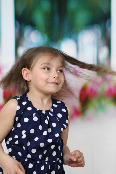 Pretty little girl with long flying hair runs - 写真・画像